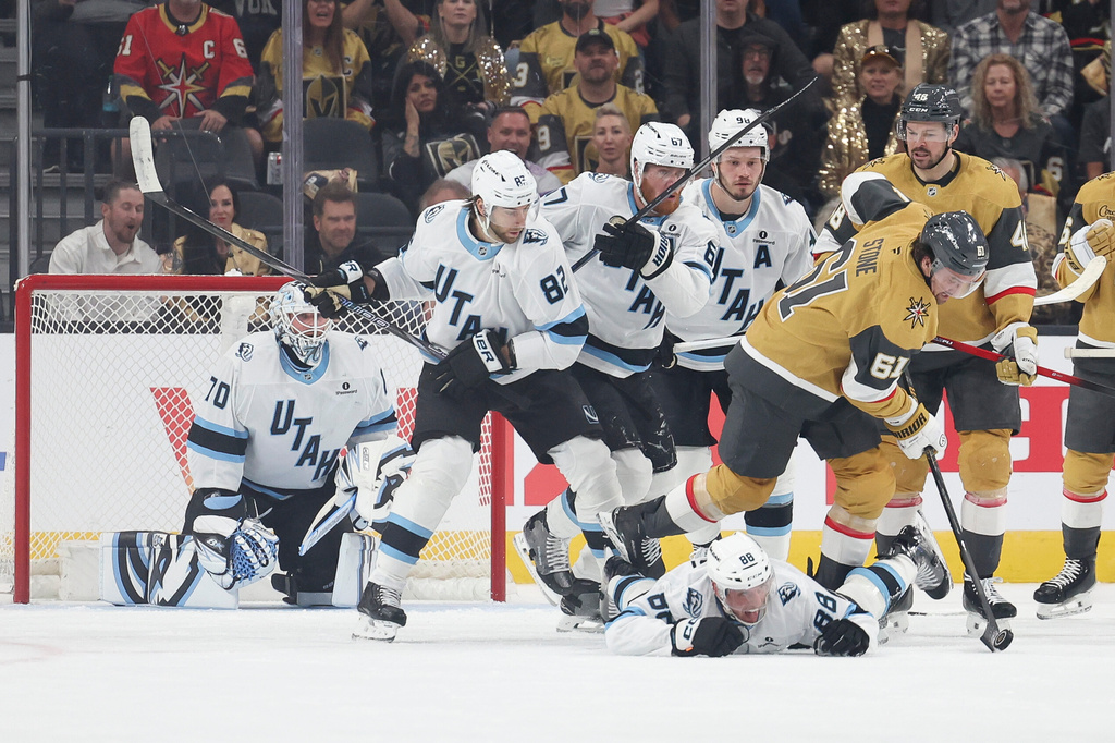 Vegas Golden Knights right wing Mark Stone (61) skates over Utah Mammoth defenseman Nate Schmidt (88) during the first period in Game 2 of a first-round NHL hockey Stanley Cup playoff series Tuesday, April 21, 2026, in Las Vegas. (AP Photo/Ian Maule)