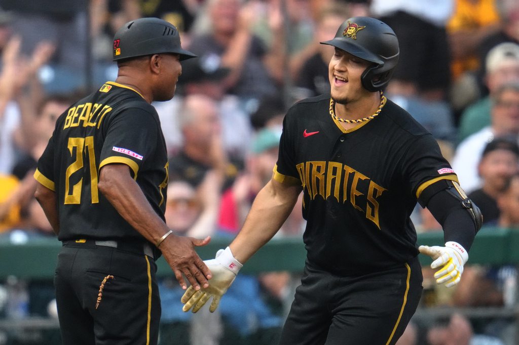 Pittsburgh Pirates' Rafael Flores Jr., right, is greeted by third base coach Tony Beasley as he rounds third base after hitting a solo home run off Boston Red Sox pitcher Jake Bennett during the second inning of a baseball game in Pittsburgh, Friday, Aug. 14, 2026. (AP Photo/Gene J. Puskar)