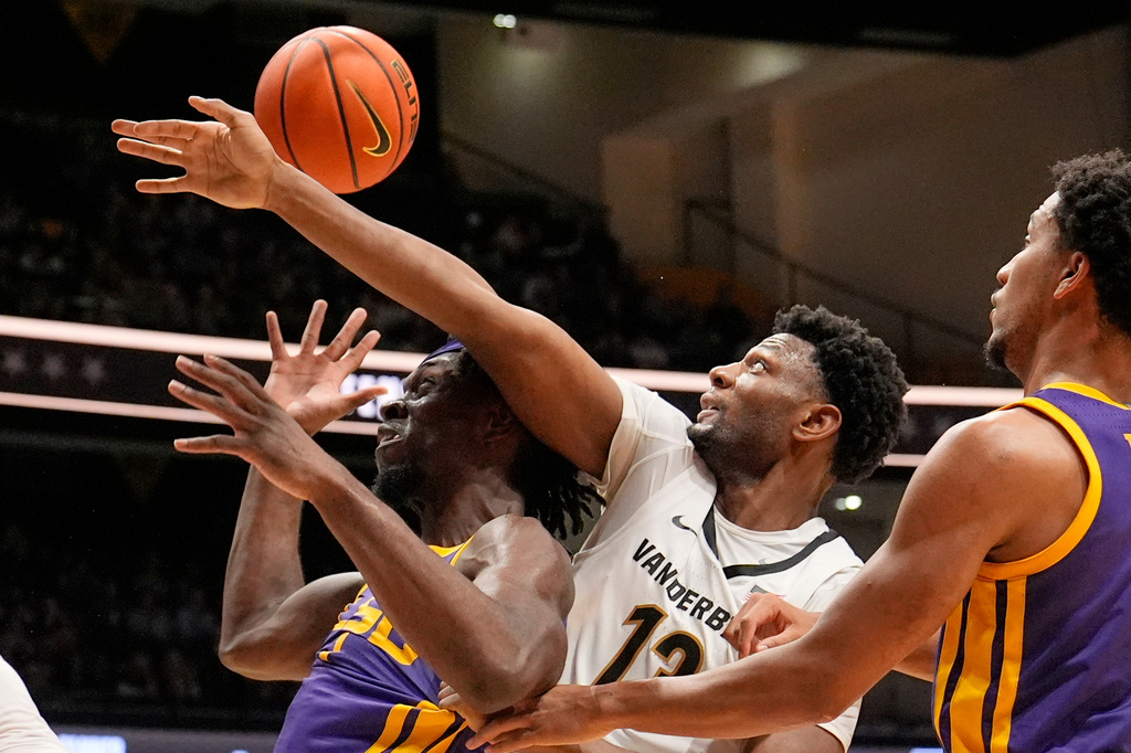 LSU forward Michael Nwoko (1) and Vanderbilt forward Jalen Washington (13) battle for a rebound during the first half of an NCAA college basketball game Saturday, Jan. 10, 2026, in Nashville, Tenn. (AP Photo/George Walker IV)