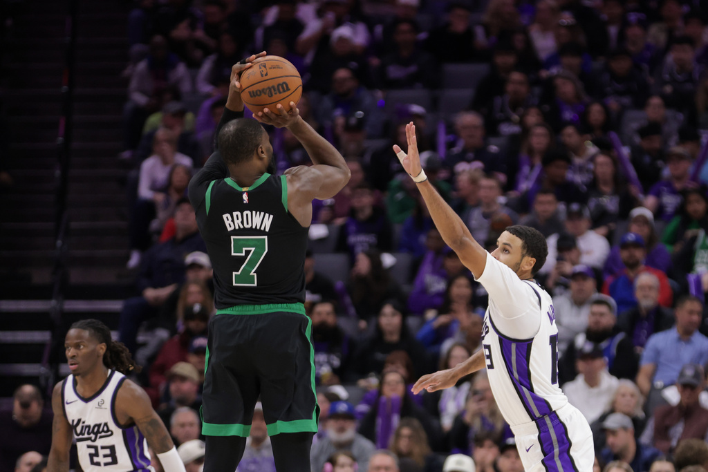 Boston Celtics guard Jaylen Brown (7) shoots a 3-point basket over Sacramento Kings forward Keegan Murray, right, during the second half of an NBA basketball game Thursday, Jan. 1, 2026, in Sacramento, Calif. (AP Photo/Scott Marshall)