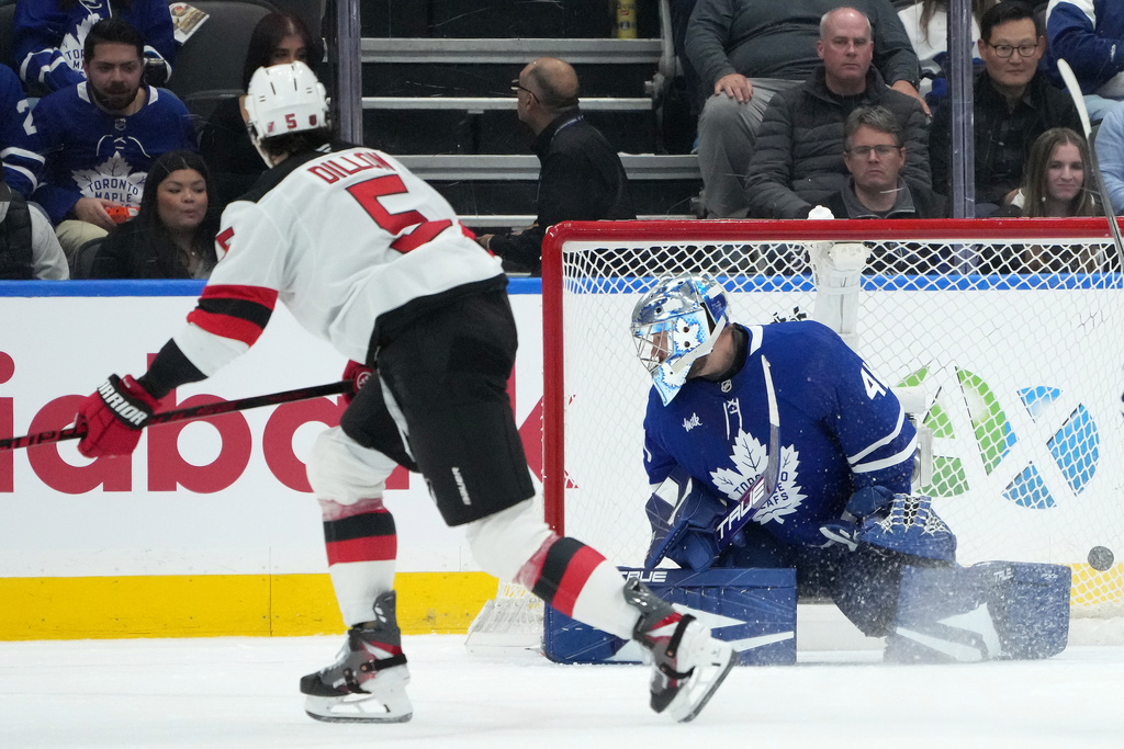 New Jersey Devils defenceman Brenden Dillon (5) scores past Toronto Maple Leafs goaltender Anthony Stolarz (41) during second period NHL hockey action in Toronto, Tuesday, Oct. 21, 2025. (Nathan Denette/The Canadian Press via AP)