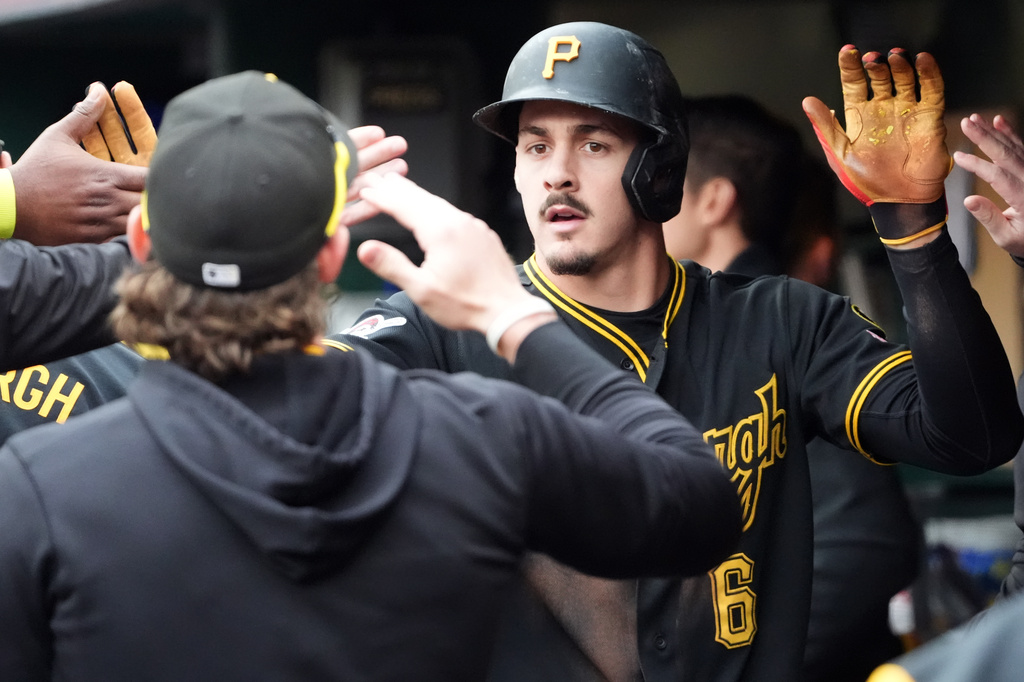 Pittsburgh Pirates' Konnor Griffin is greeted by his teammates after scoring on a single by Oneil Cruz against the Cincinnati Reds in the fourth inning of a baseball game in Pittsburgh, Saturday, May 2, 2026. (AP Photo/Tom E. Puskar)