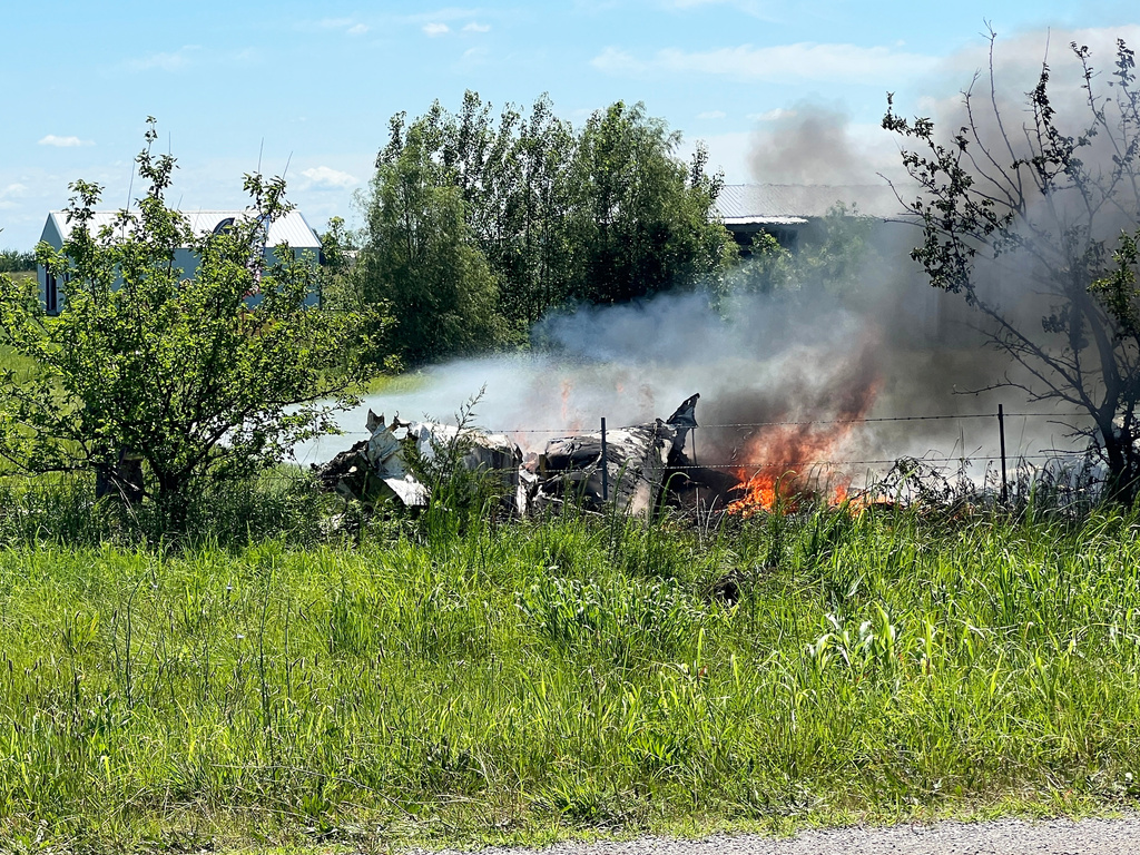 The wreckage of a plane crash burns in a field in Butler, Mo, Sunday, June 14, 2026. (Mid America News Review via AP Photo )