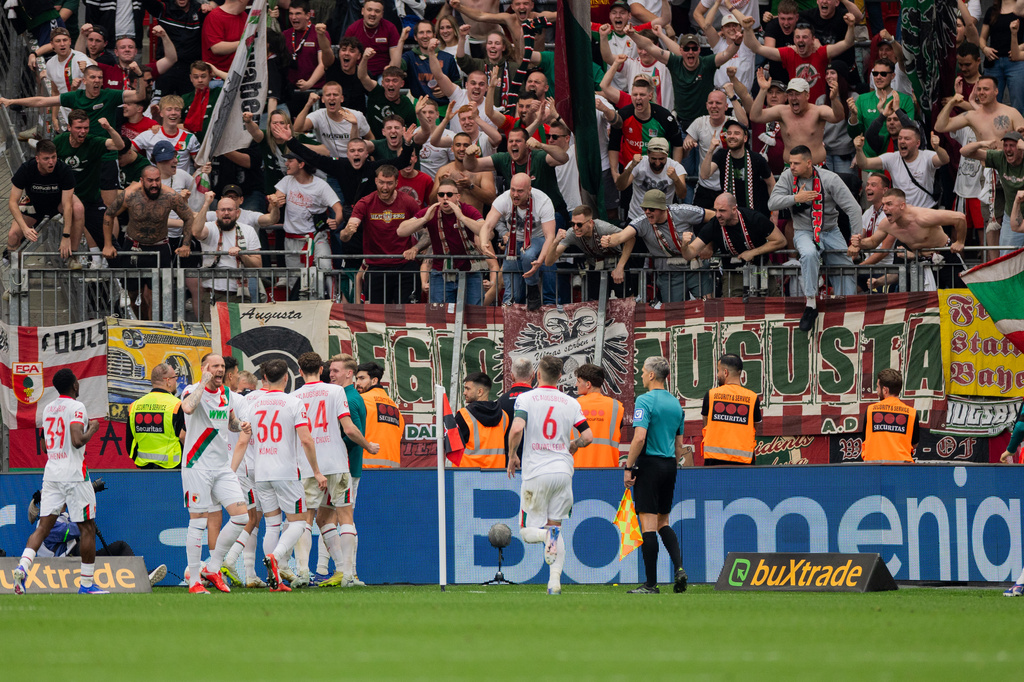 Augsburg players celebrate their goal during their German Bundesliga soccer match against Bayer Leverkusen in Leverkusen, Germany, Saturday, April 18, 2026. (Rolf Vennenbernd/dpa via AP)