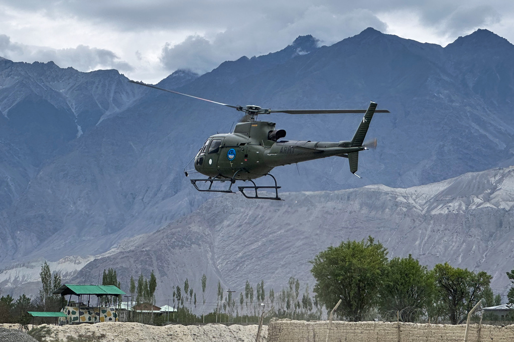 A Pakistan army helicopter carrying bodies of climbers, that were recovered from Broad Peak nearly a week after an avalanche swept away a 10-member international expedition, prepares to land at a military base in Skardu, in northern Pakistan, Thursday, Aug. 6, 2026. (AP Photo/ M.H. Balti)