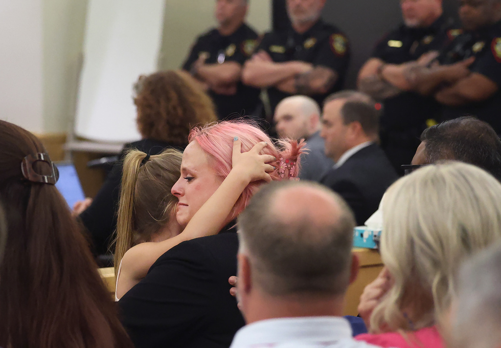 Athena Strand's mother Maitlyn Gandy, center, cries while holding her youngest daughter after the jury sentenced Tanner Horner to the death penalty in the punishment phase of Horner's capital murder trial, Tuesday, May 5, 2026, at the Tim Curry Criminal Justice Center in Fort Worth, Texas. (Amanda McCoy/Star-Telegram via AP)
