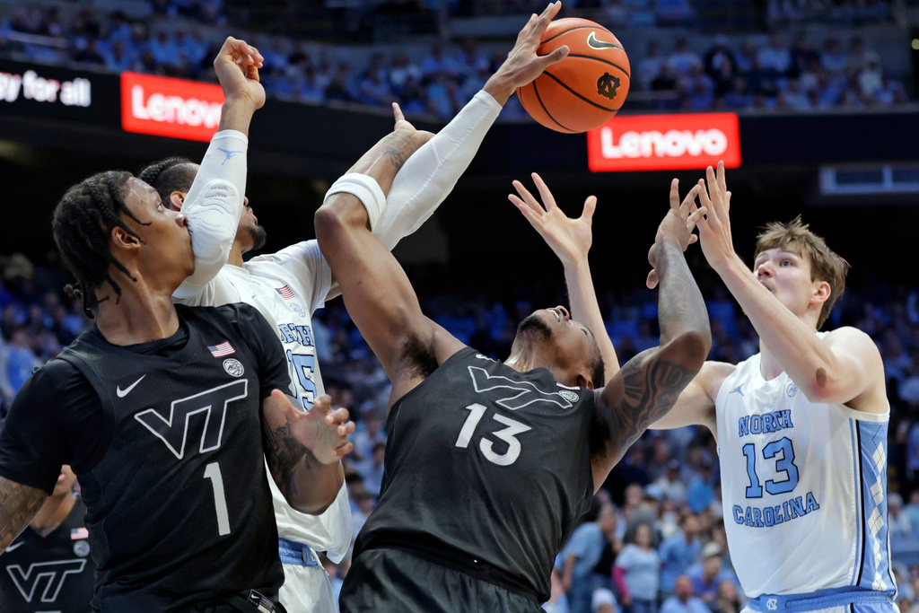 Virginia Tech forwards Tobi Lawal (1) and Amani Hansberry, second from right, battle North Carolina forward Jarin Stevenson, second from left, and center Henri Veesaar, right, for a rebound during the first half of an NCAA college basketball game Saturday, Feb. 28, 2026, in Chapel Hill, N.C. (AP Photo/Chris Seward)