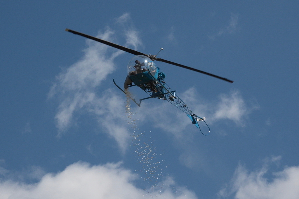 A helicopter drops marshmallows during the annual Marshmallow Drop event held at Nankin Mills Park in Westland, Mich., on Friday, April 3, 2026. (AP Photo/Mike Householder)