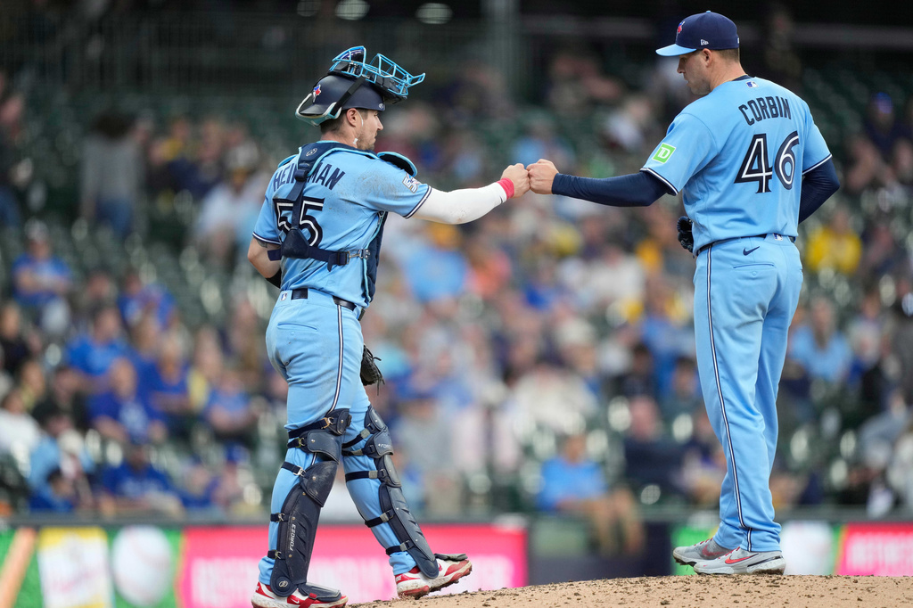 Toronto Blue Jays catcher Tyler Heineman (55) fist bumps pitcher Patrick Corbin at the mound prior to a pitching change during the sixth inning of a baseball game against the Milwaukee Brewers, Thursday, April 16, 2026, in Milwaukee. (AP Photo/Kayla Wolf)
