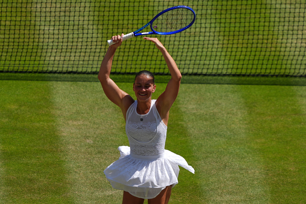 Marta Kostyuk of Ukraine dances to celebrate her victory against Jasmine Paolini of Italy in their quarter-final women's singles match at the Wimbledon Tennis Championships in London, Wednesday, July 8, 2026. (AP Photo/Maja Smiejkowska)