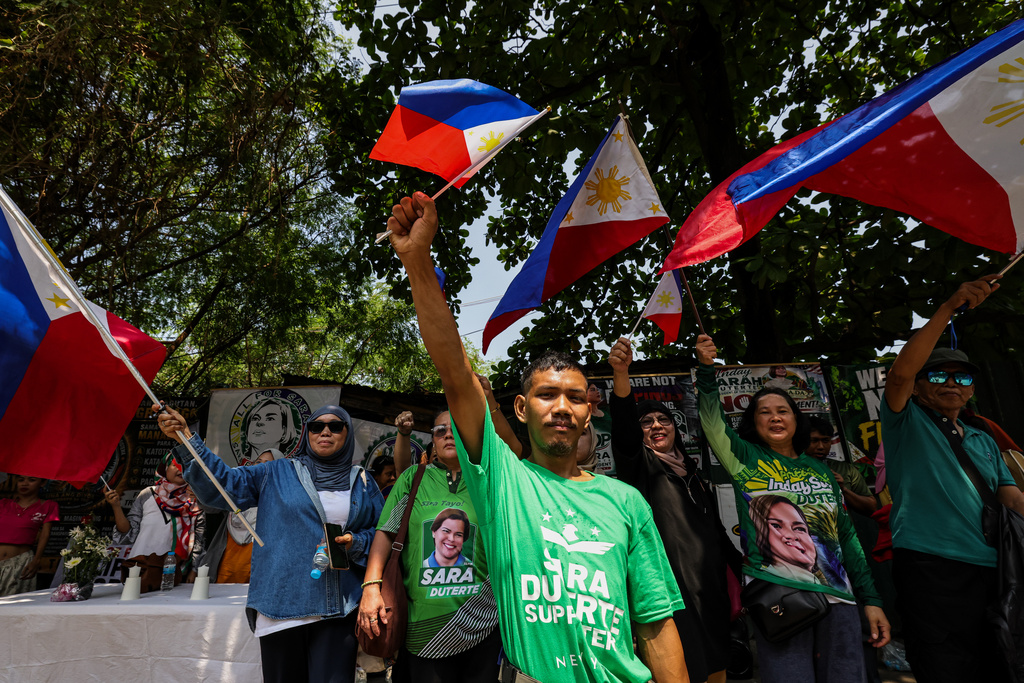 Supporters of Vice President Sara Duterte waving Philippine flags gather near the Senate in Pasay city, Philippines, Monday, July 6, 2026, ahead of the impeachment trial of Duterte. (AP Photo/Gerard Carreon)