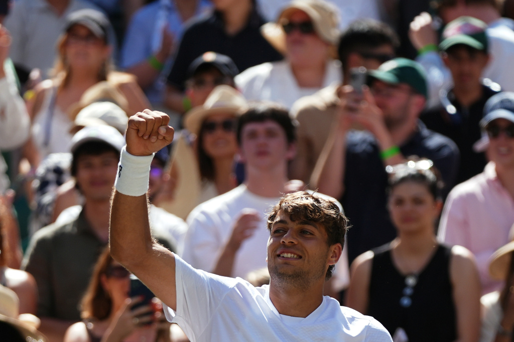Flavio Cobolli of Italy celebrates winning against Alex de Minaur of Australia in their fourth round men's singles match at the Wimbledon Tennis Championships in London, Monday, July 6, 2026. (AP Photo/Maja Smiejkowska)