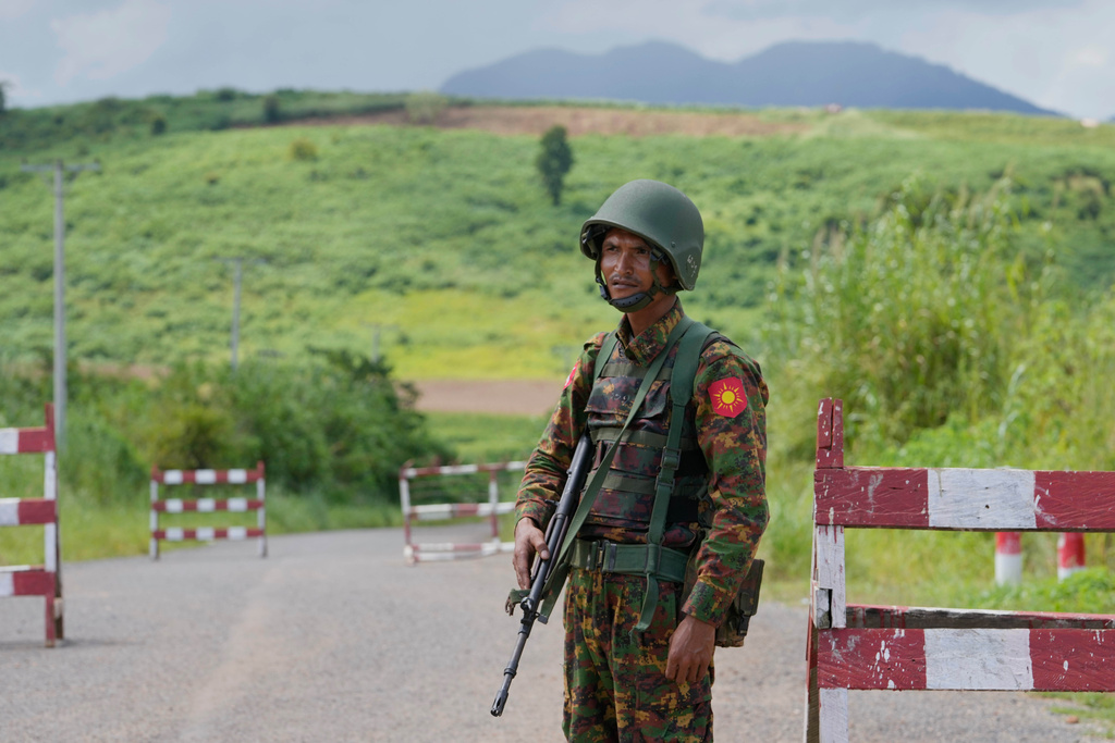 In this photo taken during a trip supervised by pro-military Myanmar media, a soldier keeps guard at a check point in Kyaukme, northern Shan State, Myanmar, Friday, Oct. 10, 2025. (AP Photo/Aung Shine Oo)