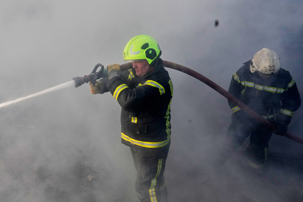 Firefighters put out the fire at a residential neighbourhood following a Russia missile and drone attack, in Brovary, close to Kyiv, Ukraine, Saturday, March 14, 2026. (AP Photo/Efrem Lukatsky)