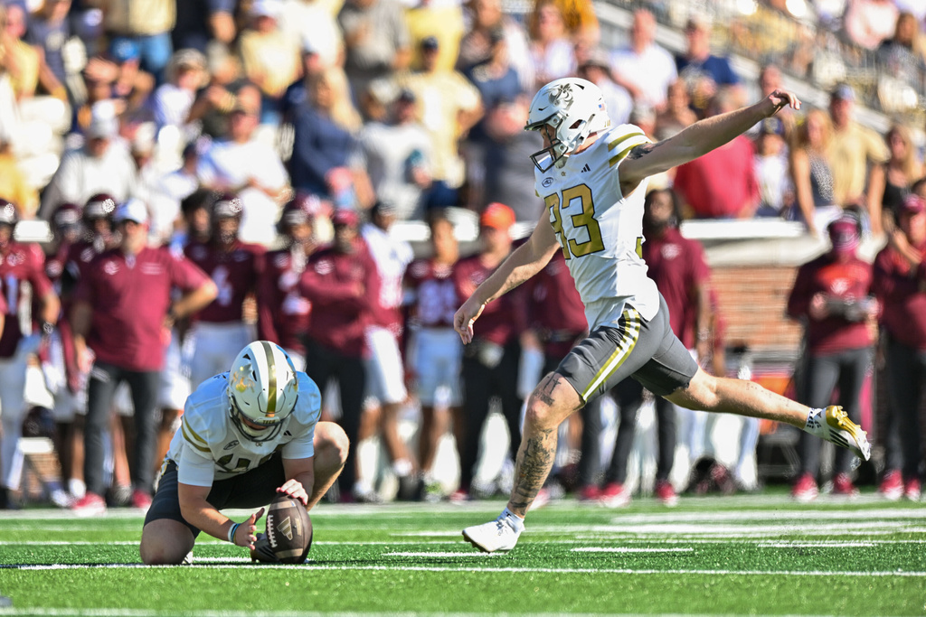 Georgia Tech punter Marshall Nichols (47) holds as kicker Aidan Birr (33) kicks a field goal during the first half of an NCAA college football game against Virginia Tech, Saturday, Oct. 11, 2025 at Bobby Dodd Stadium in Atlanta. (Daniel Varnado/Atlanta Journal-Constitution via AP)