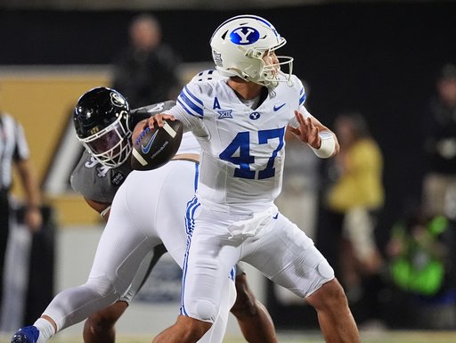 Brigham Young quarterback Bear Bachmeier, front, passes the ball as Colorado defensive tackle Tavian Coleman pursues in the first half of an NCAA college football game Saturday, Sept. 27, 2025, in Boulder, Colo. (AP Photo/David Zalubowski) Brigham Young quarterback Bear Bachmeier, front, passes the ball as Colorado defensive tackle Tavian Coleman pursues in the first half of an NCAA college football game Saturday, Sept. 27, 2025, in Boulder, Colo. (AP Photo/David Zalubowski)