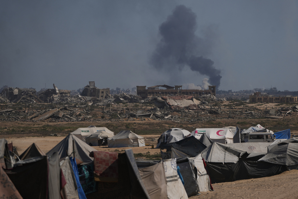 Smoke rises to the sky following an Israeli military strike in Gaza City, as seen from the central Gaza Strip, Thursday, Oct. 2, 2025. (AP Photo/Abdel Kareem Hana)