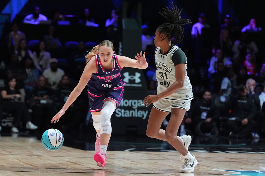 Breeze BC guard Paige Bueckers (5) drives past Phantom BC guard Tiffany Hayes (31) in their Unrivaled 3-on-3 basketball game, Monday, Jan. 5, 2026, in Medley, Fla. (AP Photo/Rebecca Blackwell)