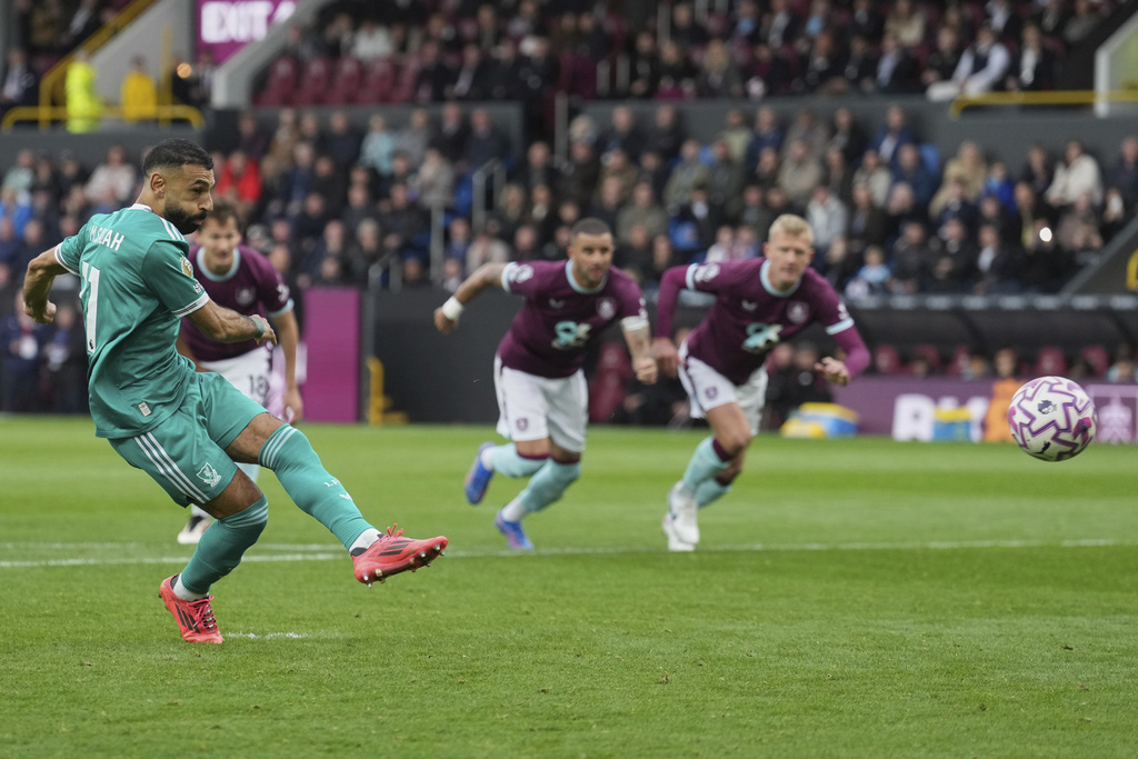 Liverpool's Mohamed Salah scores from a penalty kick during the Premier League soccer match between Burnley and Liverpool in Burnley, England, Sunday, Sept. 14, 2025. (AP Photo/Jon Super)