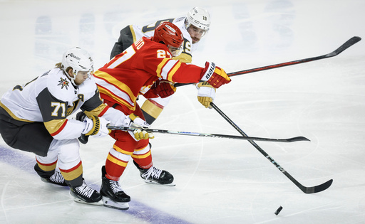 Vegas Golden Knights' William Karlsson, left, and Reilly Smith, right, check Calgary Flames' Matt Coronato during second period of an NHL hockey game in Calgary on Tuesday, Oct. 14, 2025. (Jeff McIntosh/The Canadian Press via AP) Vegas Golden Knights' William Karlsson, left, and Reilly Smith, right, check Calgary Flames' Matt Coronato during second period of an NHL hockey game in Calgary on Tuesday, Oct. 14, 2025. (Jeff McIntosh/The Canadian Press via AP)