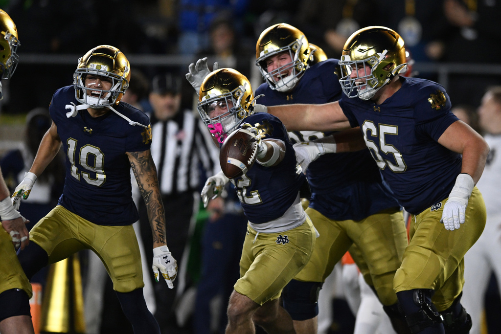Notre Dame running back Aneyas Williams, center, celebrates with teammates after rushing for a touchdown during the fourth quarter of an NCAA football game against Syracuse, Saturday, Nov. 22, 2025, in South Bend, Ind. (AP Photo/Paul Beaty)