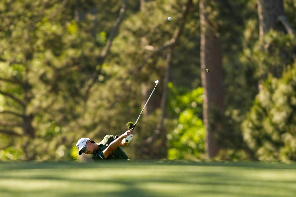 Min Woo Lee, of Australia, hits from the fairway on the 17th hole during the first round of the Masters golf tournament at the Augusta National Golf Club, Thursday, April 9, 2026, in Augusta, Ga. (AP Photo/Gerald Herbert)