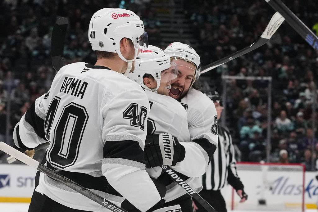 Los Angeles Kings left wing Kevin Fiala, center, celebrates his goal with right wing Joel Armia (40) and defenseman Drew Doughty (8) during the third period of an NHL hockey game Wednesday, Dec. 10, 2025, in Seattle. (AP Photo/Lindsey Wasson)
