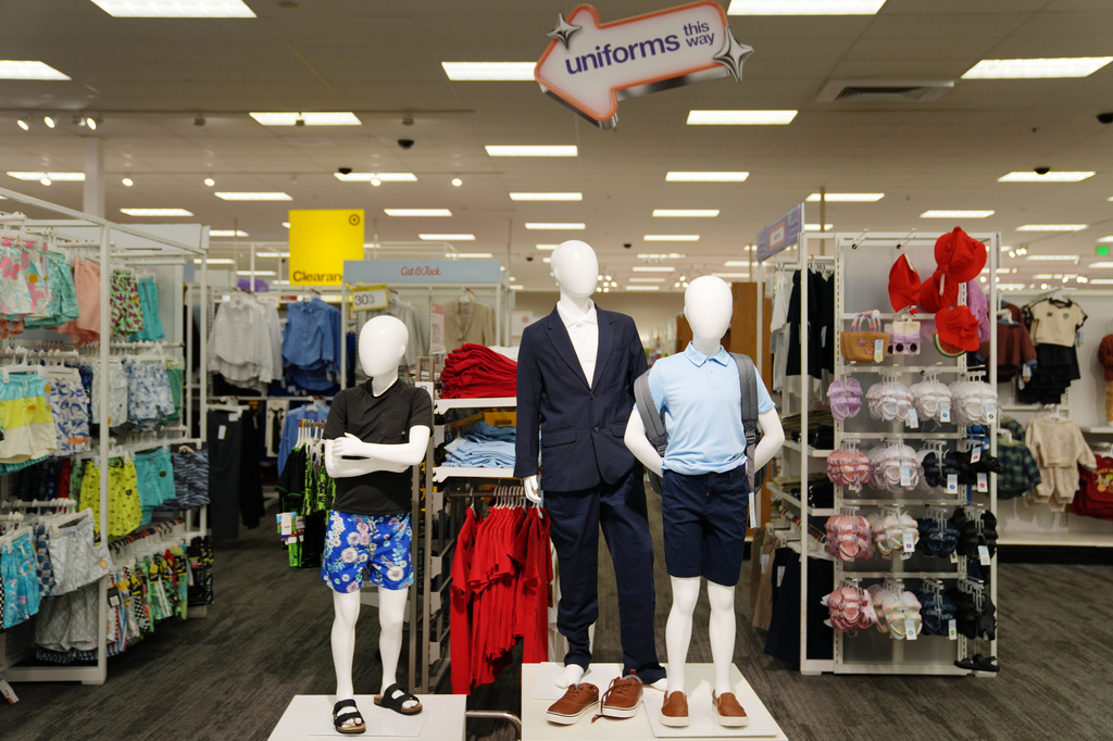 Children's clothing including uniforms are on display in a Target store, Thursday, Aug. 13, 2026, in Woodbury, Minn. (AP Photo/Ellen Schmidt)