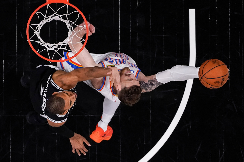 Oklahoma City Thunder center Isaiah Hartenstein (55) shoots against San Antonio Spurs forward Victor Wembanyama (1) in the second half of Game 6 in the Western Conference finals NBA basketball playoffs series, Thursday, May 28, 2026, in San Antonio. (AP Photo/David J. Phillip)