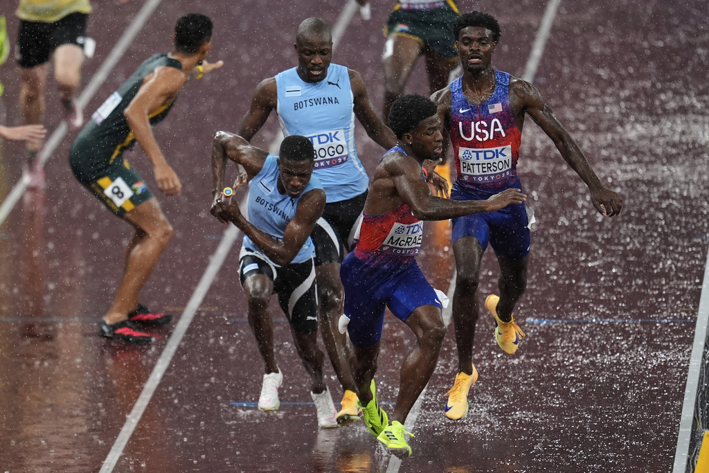Botswana's Bayapo Ndori receives the baton from Letsile Tebogo as United States' Khaleb McRae receives the baton from United States' Jacory Patterson in the men's 4 X 400 meters relay final at the World Athletics Championships in Tokyo, Sunday, Sept. 21, 2025. (AP Photo/Abbie Parr)