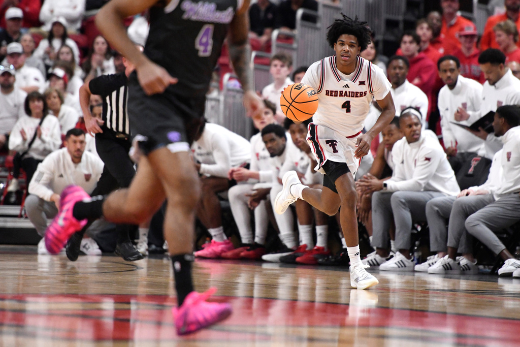 Texas Tech guard Christian Anderson (4) dribbles the ball down the court during the first half in an NCAA college basketball game against Kansas State, Saturday, Feb. 21, 2026, in Lubbock, Texas. (AP Photo/Annie Rice)