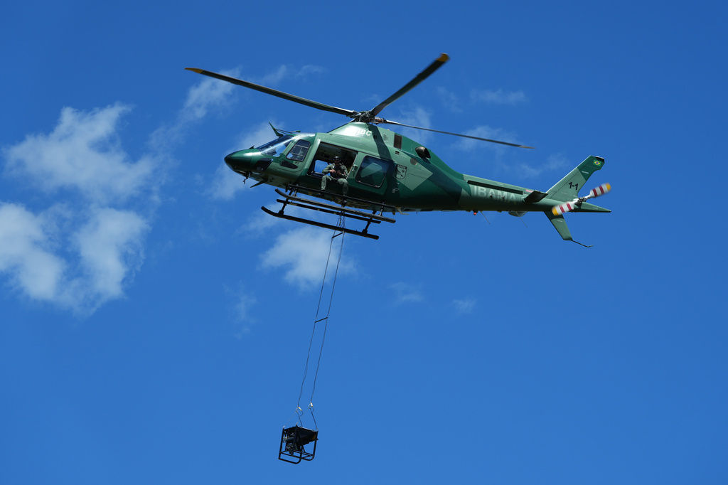 Officers from IBAMA, Brazil's environmental protection agency, drop fire-starting balls from a helicopter for a controlled burn as part of a fire prevention operation at the Xerente Indigenous territory, near Tocantinia, Tocantins state, Brazil, Tuesday, May 19, 2026. (AP Photo/Andre Penner)