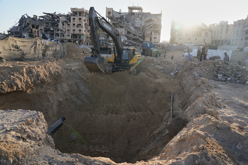 Palestinians watch machinery and some workers from Egypt searching for the bodies of hostages at Hamad City, in Khan Younis, southern Gaza Strip, Monday, Oct. 27, 2025. (AP Photo/Jehad Alshrafi) Palestinians watch machinery and some workers from Egypt searching for the bodies of hostages at Hamad City, in Khan Younis, southern Gaza Strip, Monday, Oct. 27, 2025. (AP Photo/Jehad Alshrafi)