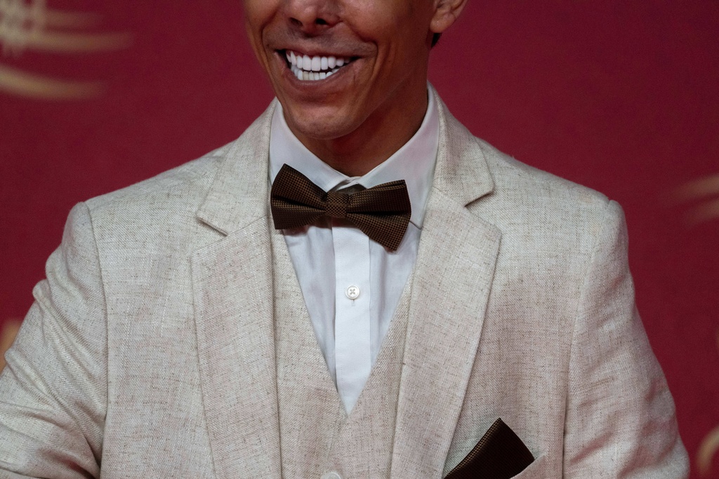 An actor poses for a photo on the red carpet during the 22nd Marrakech Film Festival, in Morocco, Tuesday, Dec. 2, 2025. (AP Photo/Mosa'ab Elshamy)