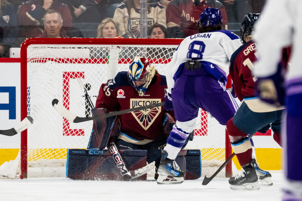 Minnesota Frost's Samantha Cogan (8) scores on Montreal Victoire goaltender Ann-Renee Desbiens (35) during the second period of a PWHL hockey playoff game in Laval, Quebec, on Tuesday, May 12, 2026. (Christopher Katsarov/The Canadian Press via AP)
