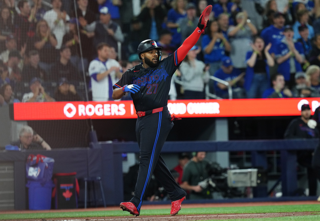 Toronto Blue Jays' Vladimir Guerrero Jr. celebrates as he scores against the Minnesota Twins during fourth-inning baseball game action in Toronto, Friday, April 10, 2026. (Chris Young/The Canadian Press via AP)