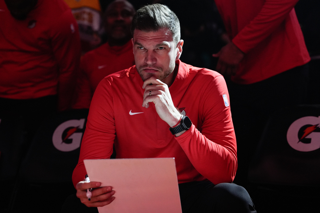 FILE - Portland Trail Blazers interim head coach Tiago Splitter listens during introductions before an NBA basketball game against the Brooklyn Nets, March 23, 2026, in Portland, Ore. (AP Photo/Jenny Kane, File)