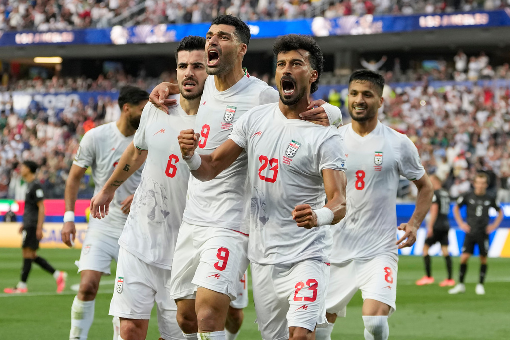 Iran's Ramin Rezaeian (23) celebrates with his teammates after scoring a goal during the World Cup Group G soccer match between Iran and New Zealand in Inglewood, Calif., near Los Angeles, Monday, June 15, 2026. (AP Photo/Andre Penner)