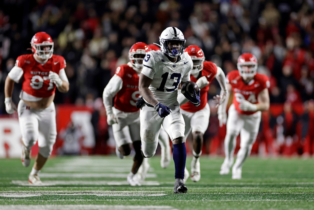 Penn State running back Kaytron Allen (13) runs with the ball past the Rutgers defense during the second half of an NCAA college football game Saturday, Nov. 29, 2025, in Piscataway, N.J. (AP Photo/Adam Hunger)