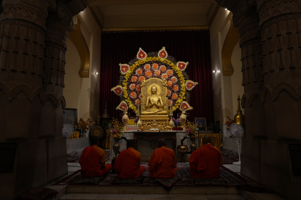 Buddhist monks pray inside a monastery in Sarnath, India, Saturday, July 18, 2026. (AP Photo/Rajesh Kumar Singh)