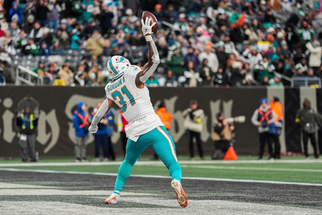 Miami Dolphins running back Ollie Gordon II (31) reacts after scoring a touchdown against the New York Jets during the fourth quarter of an NFL football game, Sunday, Dec. 7, 2025, in East Rutherford, N.J. (AP Photo/Yuki Iwamura)