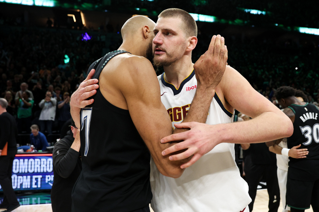Denver Nuggets center Nikola Jokic, right, and Minnesota Timberwolves center Rudy Gobert hug after Game 6 of a first-round NBA basketball playoffs series, Thursday, April 30, 2026, in Minneapolis. (AP Photo/Matt Krohn)