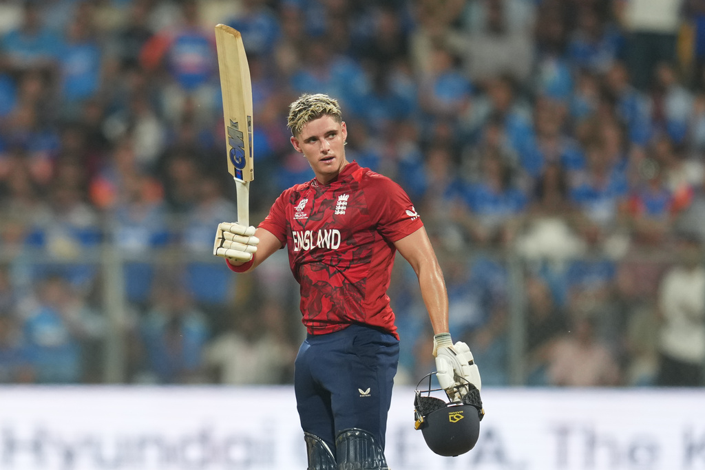 England's Jacob Bethell celebrates after scoring a century during the T20 World Cup cricket semi-final match between India and England in Mumbai, India, Thursday, March 5, 2026. (AP Photo/Rafiq Maqbool)