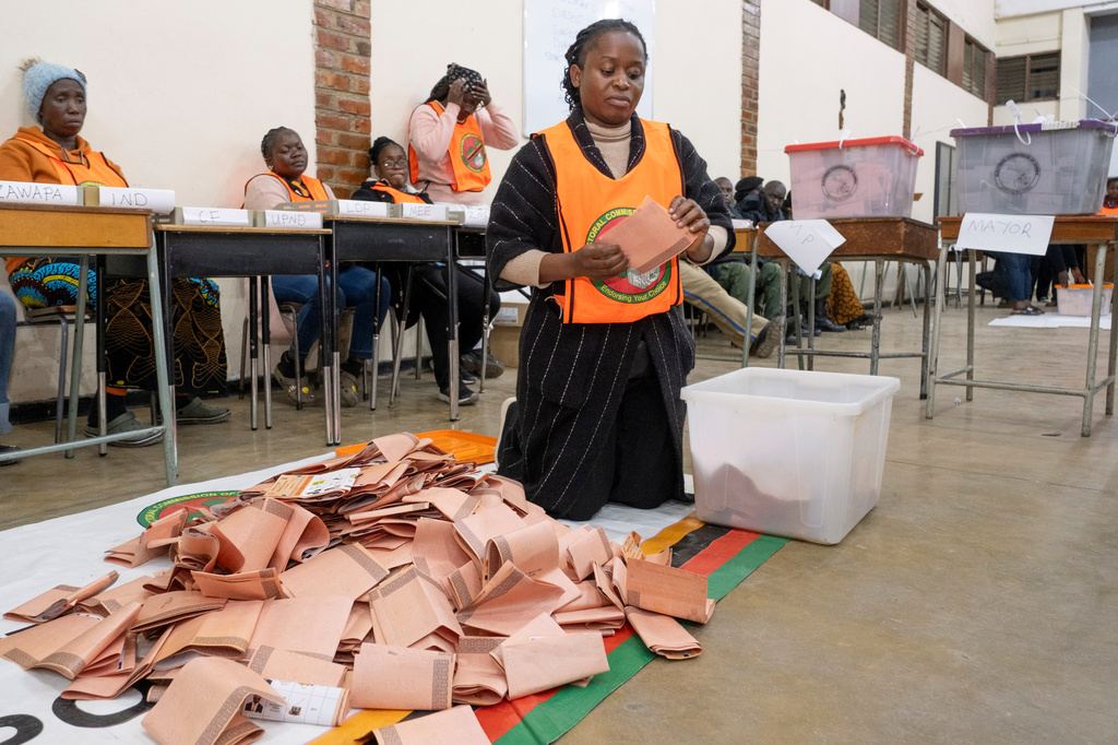 An election worker holds a ballot as counting starts in Lusaka, Zambia, Thursday, Aug. 13, 2026. (AP Photo/Anita Reed)