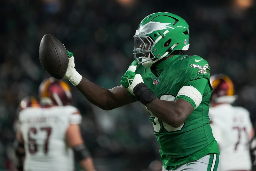 Philadelphia Eagles linebacker Jalyx Hunt (58) celebrates an interception during the first half of an NFL football game against the Washington Commanders on Sunday, Jan. 4, 2026, in Philadelphia. (AP Photo/Matt Slocum)