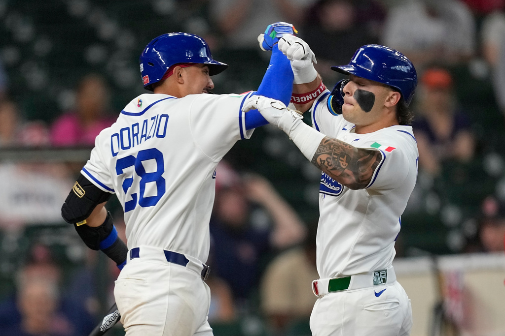 Italy's Andrew Fischer, right, celebrates with JJ D'Orazio (28) after hitting a home run against Britain during the third inning of a World Baseball Classic game, Sunday, March 8, 2026, in Houston. (AP Photo/David J. Phillip)
