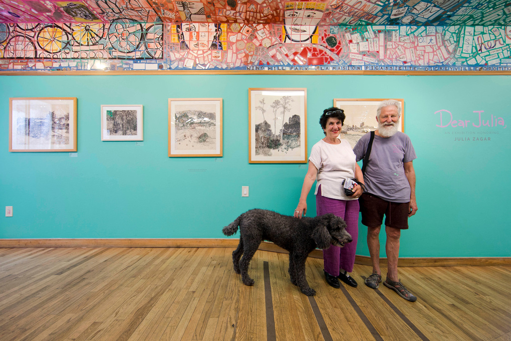 FILE - Julia Zagar, left, and her husband Isaiah Zagar pose for a photo with their dog Blue at the "Dear Julia" exhibit at Philadelphia's Magic Gardens May 26, 2016, in Philadelphia. (AP Photo/Matt Rourke, File)