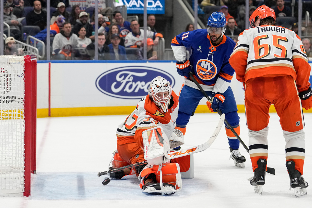 Anaheim Ducks goaltender Ville Husso (33) protests the net from New York Islanders left wing Anthony Duclair (11) during the second period of an NHL hockey game, Thursday, Dec. 11, 2025, in Elmont, N.Y. (AP Photo/Yuki Iwamura)