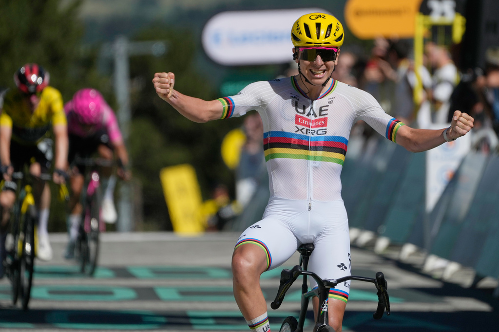 Slovenia's Tadej Pogacar celebrates as he crosses the finish line to win the third stage of the Tour de France cycling race with start in Granollers and finish in Les Angles , France, Monday, July 6, 2026. (AP Photo/Mosa'ab Elshamy)