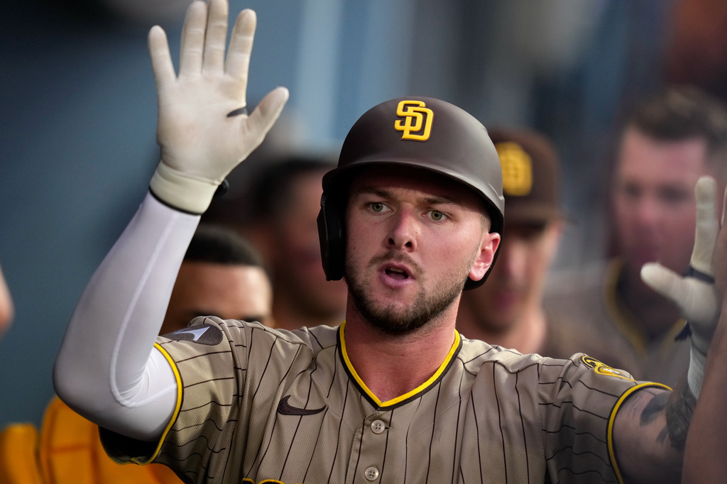 San Diego Padres' Jackson Merrill is congratulated by teammates in the dugout after hitting a solo home run during the fourth inning of a baseball game against the Los Angeles Dodgers, Friday, July 3, 2026, in Los Angeles. (AP Photo/Mark J. Terrill)